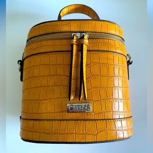 Carlos Santana yellow gold top handle bucket bag.